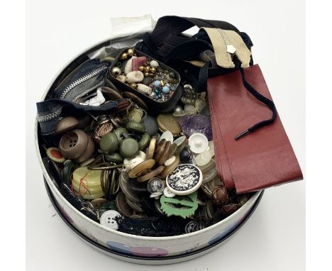 A tin of vintage buttons and various haberdashery 