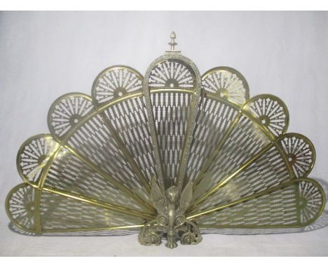 A brass fan shaped fire screen.