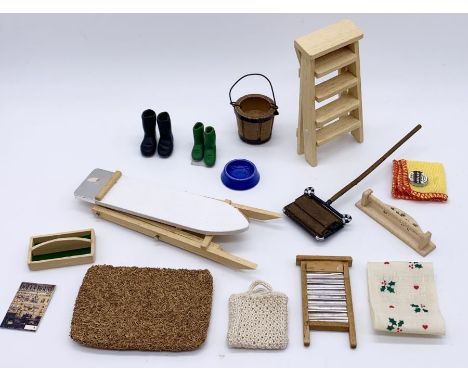 A collection of miniature dolls house kitchen items including ironing board, step ladder, carpet sweeper etc.