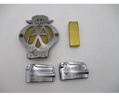 A Malaya AA car badge numbered N10783 , along with three vintage lighters including two Ronson's and one Dunhill.