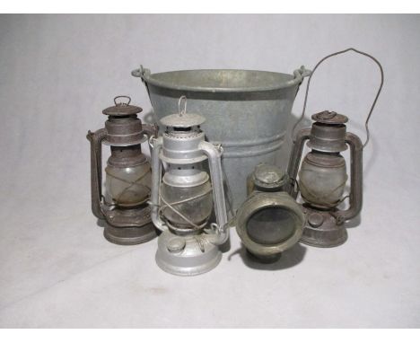 Three vintage lamps along with a galvanised bucket and Powell &amp; Hanmer "New Sultan" carbide cycle lamp.