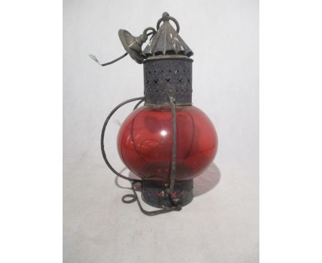 A lantern style ceiling pendant with ruby red shade.