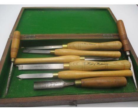 A collection of woodworking tools in wooden box