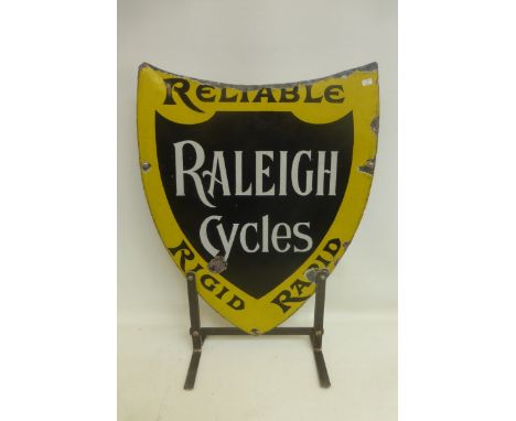 A Raleigh Cycles "Reliable, Rigid and Rapid" shield shaped enamel sign, mounted on a metal stand, 17 1/2 x 21 1/2".