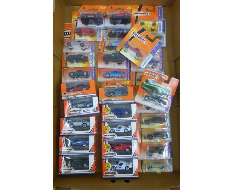 A box of Matchbox models including contemporary "Mattel Wheels" series, many in the form of classic cars such as the Jaguar E