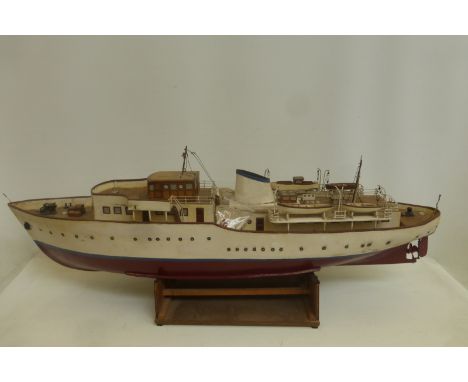 A well constructed motorised scale model of a boat, with a squat funnel and lifeboats etc.