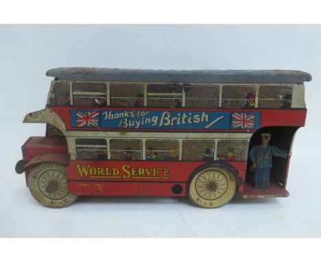 A tinplate model bus, with advertising all around.