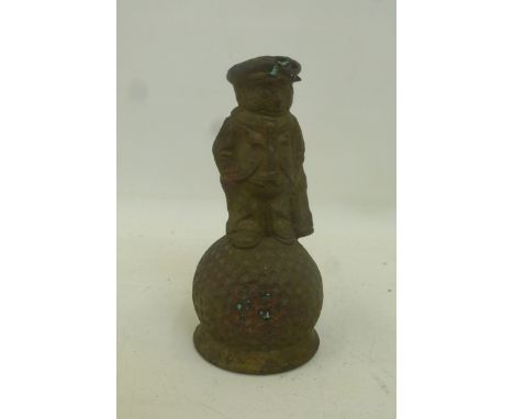 An original brass Dunlop counter top bell in the form of a "man-caddy" sat on a golf ball.