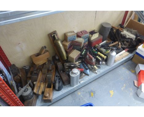 A large quantity of tools, flat irons and packaging relating to an early ironmongers.