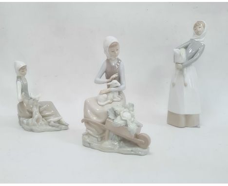 Lladro figure of a girl holding a lamb, 27cm high, a Lladro model of a seated girl with lamb and a wheelbarrow of produce and