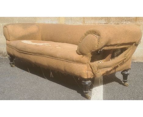 In the manner of Howard & Sons of London three-seat Chesterfield sofa on turned legs, brass Howard-type castors, with peach g