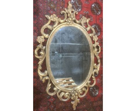Modern oval mirror in gold coloured sprayed acanthus leaf moulded frame, 83cm x 52cm