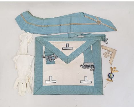 Old brown leather case of masonic regalia to include sash, enamelled badge, white metal pendant and apron and another, larger