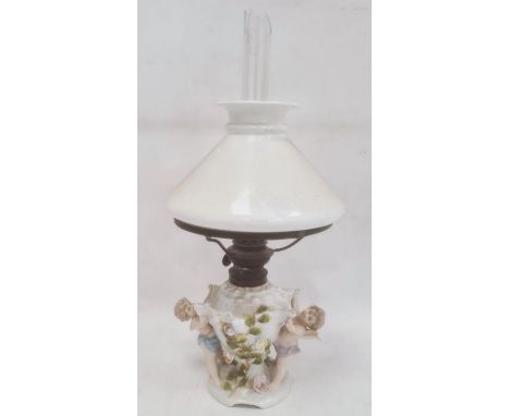 German porcelain oil lamp base shell-shaped form, flower encrusted , supported by cherubs together with the opaque shade, cle