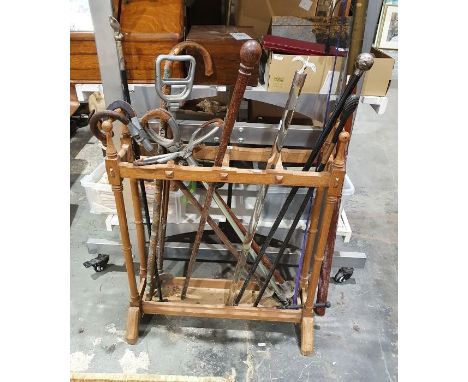 Stickstand and contents including a turned ebony stick, a stick with silver finial, shooting sticks, etc