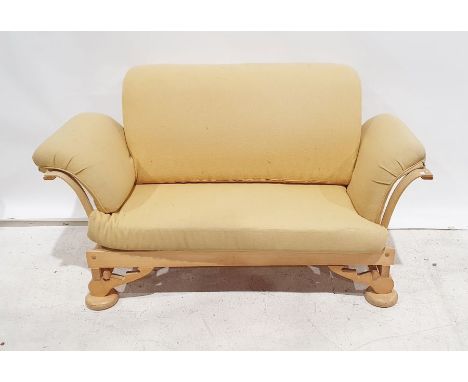 1960s/70s oak framed two seater sofa in pale yellow upholstery with adjustable scroll ends