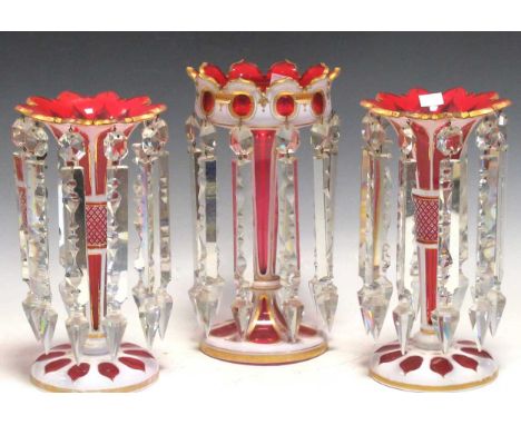 A pair of ruby flash lustres 28.5cm high and a larger single lustre 30cm high (3)Generally good condition on the body. Rubbin