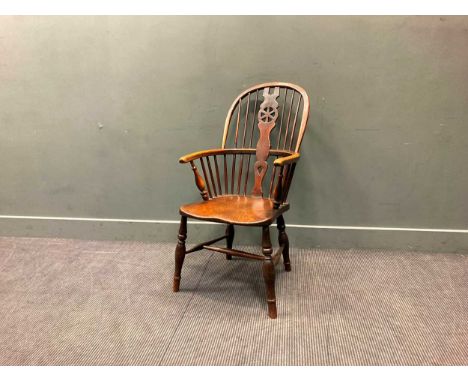 An early 19th century beech and elm Windsor wheel back armchair, 99 x 52 x 64cmStructurally good with some movement, rocks fr