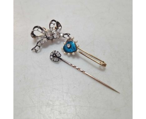 A diamond set horseshoe stick pin, together with a diamond and pearl heart brooch, and a diamond set bow brooch, gross weight