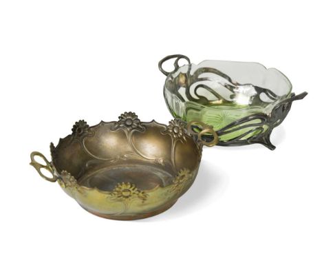 A WMF pierced bowl with glass liner, the lobed and star cut liner with green staining and set within a twin-handled scrolling