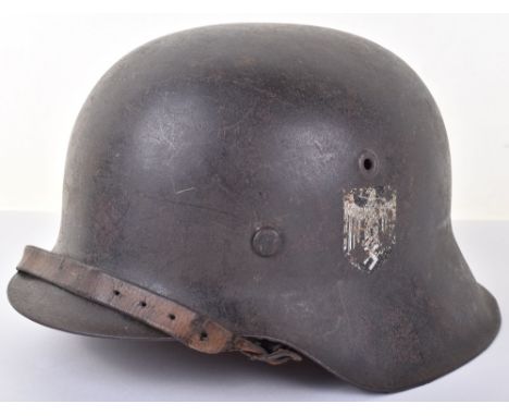 WW2 German Army M-42 Steel Combat Helmet, good combat example retaining much of the original field grey combat paint finish t