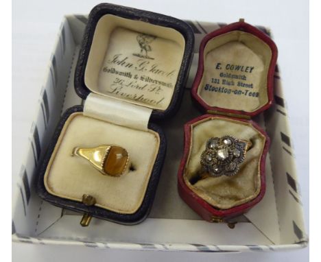 A late Victorian yellow metal cluster ring; and a 9ct gold tiger's eye signet ring       11