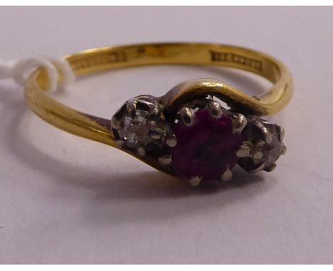 An 18ct gold crossover, claw set ruby and diamond ring       11