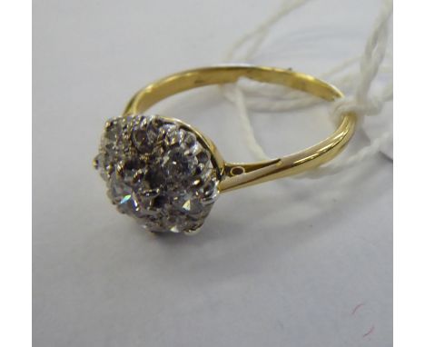 An 18ct gold claw set diamond cluster ring       11
