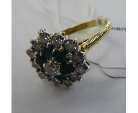 An 18ct gold emerald and diamond cluster ring       11