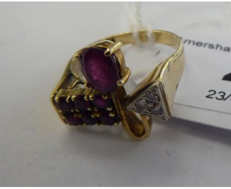 A designer 14ct gold ruby and diamond set ring       11