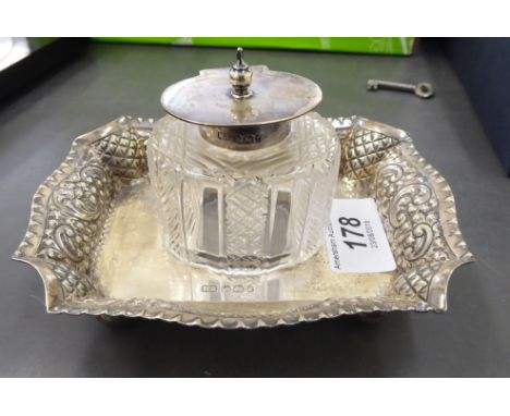 A silver deskstand with a cut glass inkwell and silver lid  mixed Sheffield marks  4''h overall       CS