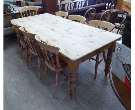 A modern honey coloured pine farmhouse kitchen table with a scrubbed, planked top, raised on ring turned baluster legs  30''h