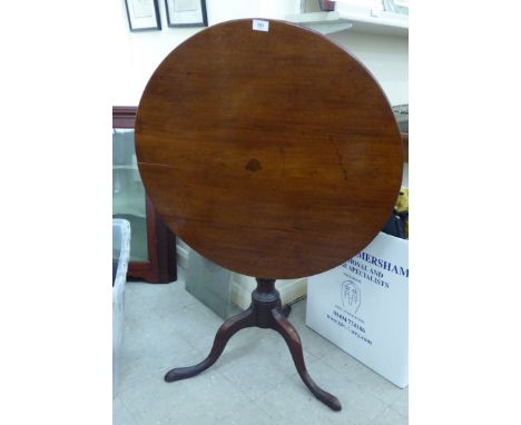 An early 19thC mahogany pedestal table, the tip-top over a vase turned column, raised on a cabriole tripod base  28''h  28''d