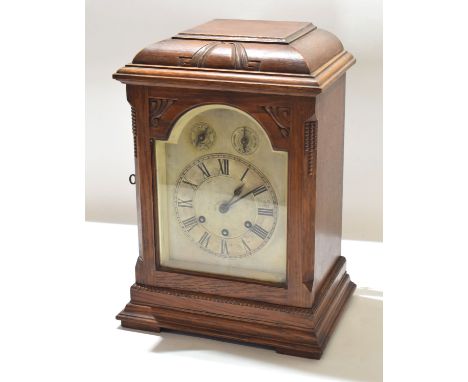 Early 20th century oak cased bracket clock^ arched silvered face with Roman chapter ring^ separate chime^ silent and minutes 