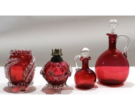 Group of cranberry glass wares including two decanters with stoppers^ further small cranberry oil lamp and vase with applied 