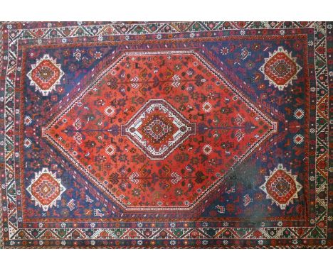 A zoomorphic Qashqai carpet on a red &amp; blue ground, contained by geometric borders, 320 x 226cm 