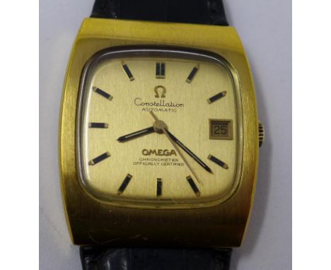An Omega Constellation automatic chronometer wristwatch, gilt dial with baton markers and date aperture at 3, on an associate