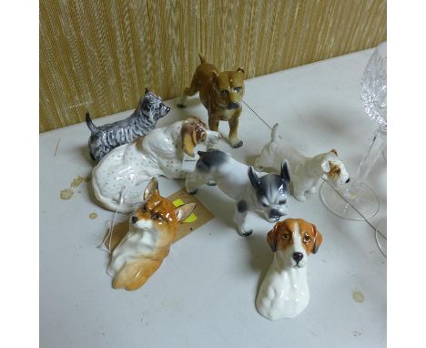 A collection of porcelain dogs to include Royal Doulton and Royal Worcester 