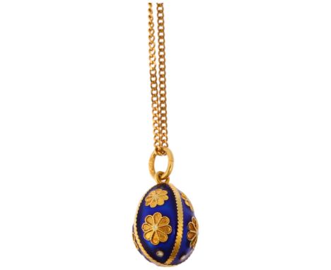 A Continental 18ct gold blue enamel egg pendant necklace, on 18ct fine curb link chain, the egg decorated with floral motifs,