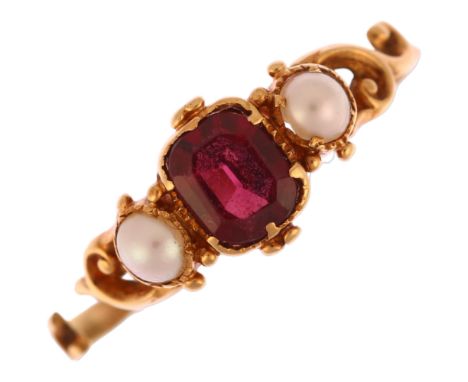 A Victorian three stone garnet and split pearl dress ring, unmarked gold pierced foliate settings, setting height 6.8mm, size