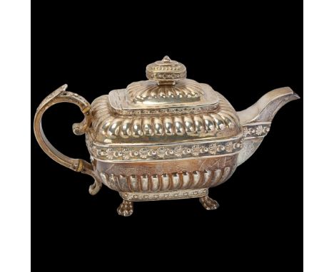 A George III silver teapot, indistinct maker, London 1812, bulbous rectangular form, with relief embossed half fluted decorat