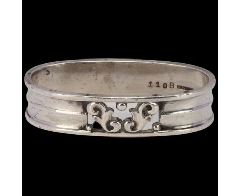 GEORG JENSEN and WENDEL - an Art Deco Danish sterling silver oval napkin ring, with pierced foliate decoration, model no. 110