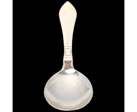 GEORG JENSEN - a Danish stylised sterling silver Antik/Continental tea caddy spoon, circa 1927, planished bowl, 11.5cmNo dama