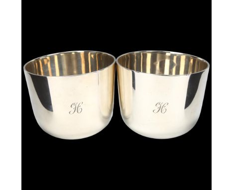 A heavy pair of George V silver tumbler beakers, Edward Barnard & Sons Ltd, London 1925, retailed by Payne of Oxford, plain t