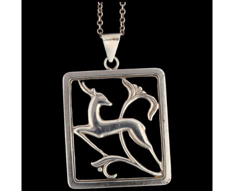 C A CHRISTENSENS - an Art Deco Danish silver gazelle openwork pendant necklace, on silver cable link chain, pendant 51.5mm, c