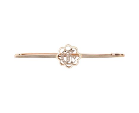 A Victorian 15ct gold enamel and diamond initial E bar brooch, circa 1880, the central openwork lobed white enamel frame cont