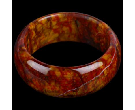 A large polished pietersite agate slave bangle, band width 26.6mm, internal circumference 18cm, 102.9gNo damage or repair 