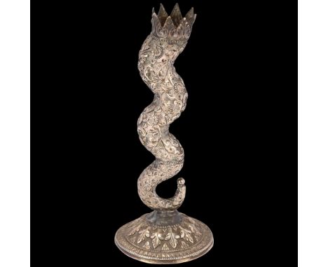 An Indian silver serpentine candlestick, early 20th century, allover relief embossed floral decoration with chased ground, ap