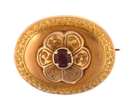 A Victorian garnet memorial brooch, unmarked yellow metal closed-back settings, of oval form with central engraved flowerhead