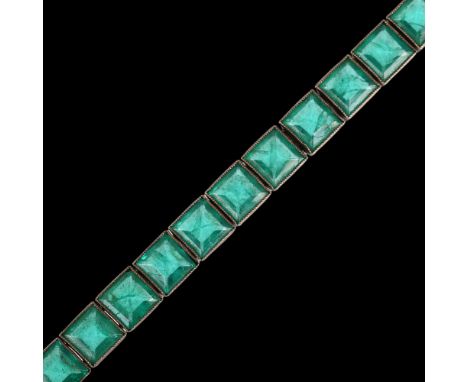 An Art Deco Continental silver green paste line bracelet, set with square step-cut paste, 18cm, 20.9gNo damage or repair, all